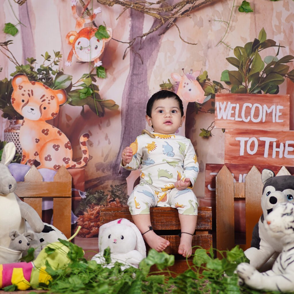 Cute baby in a jungle themed photography setup