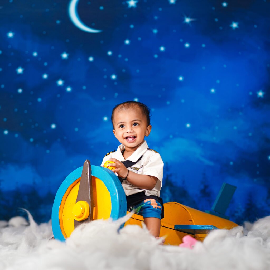 Baby in a cute aeroplane themed photography setup